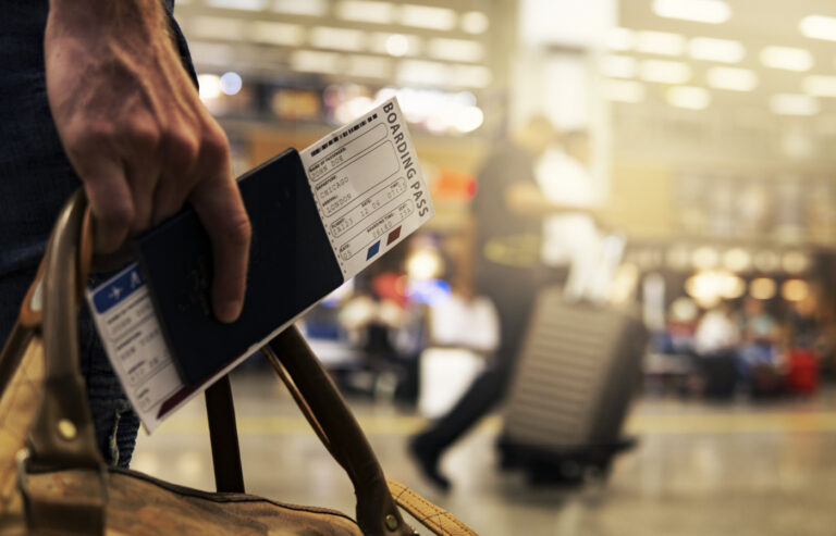 Traveller holding passport and boarding pass at airport