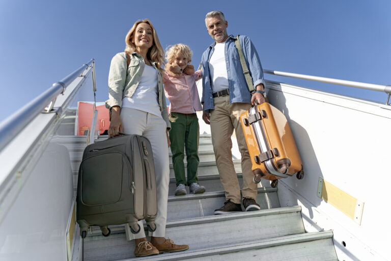 Newcomer family arriving in Canada with suitcases