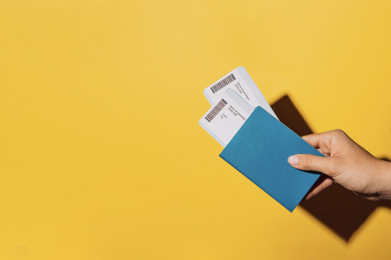 Hand holding boarding passes for Canadian travel
