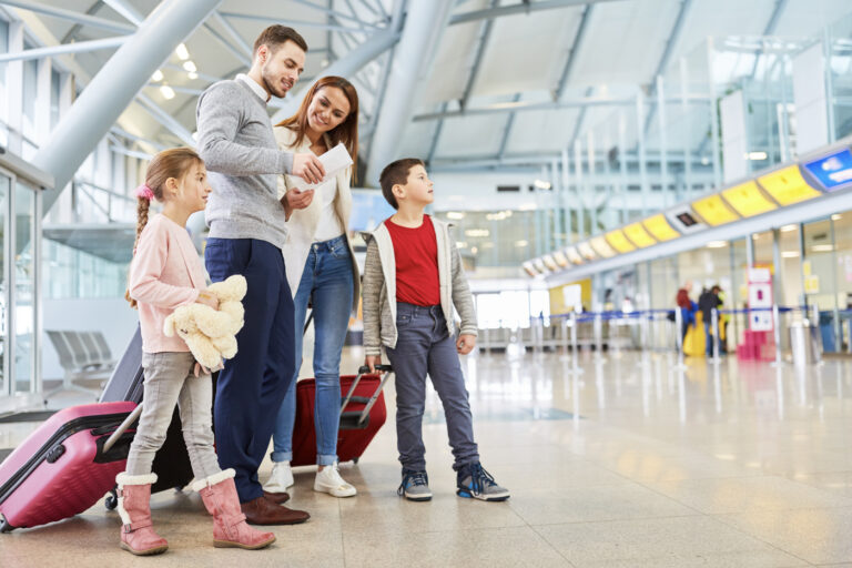 Newcomer family at Canadian airport with immigration documents