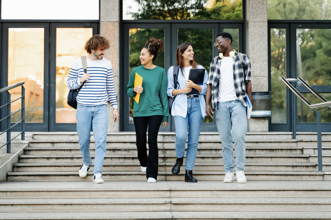 Diverse students discussing Canadian degree options in library