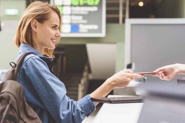 Newcomer presenting passport for Canadian visa processing