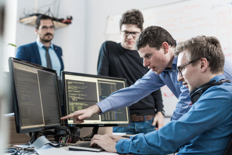 International professionals in tech reviewing LMIA-exempt work permits