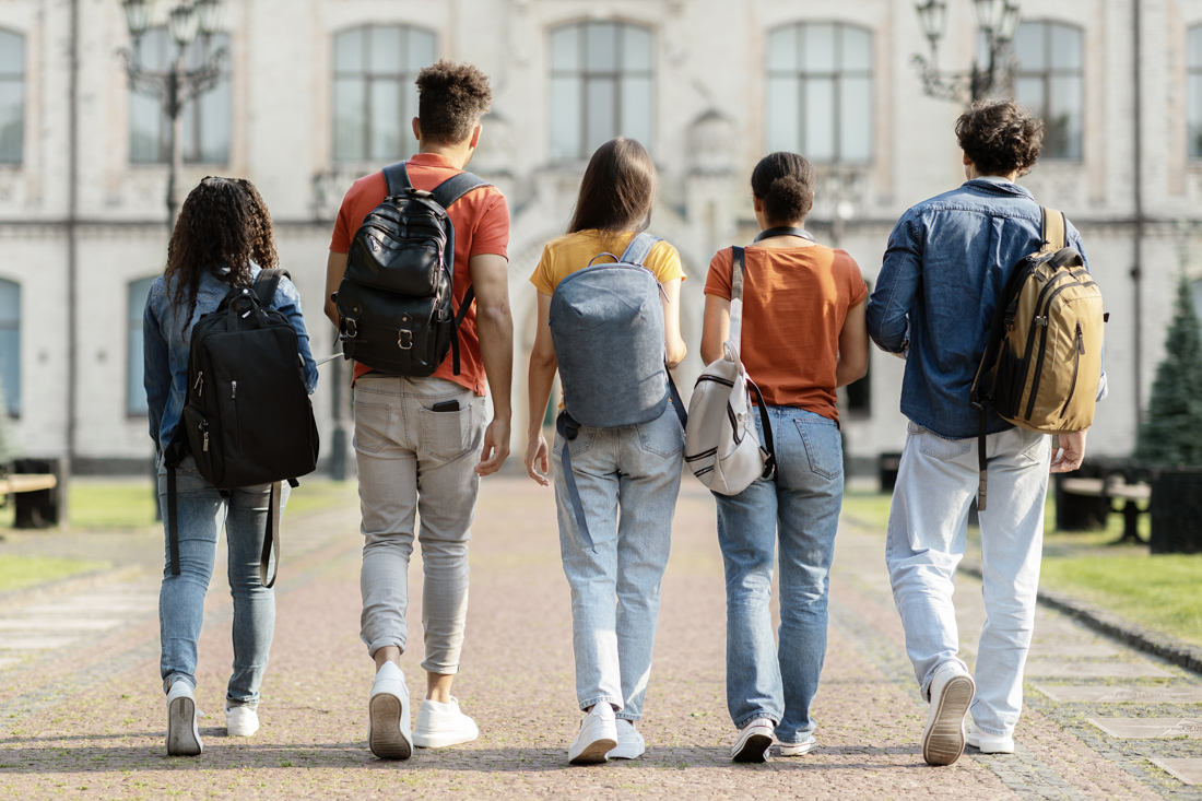 Diverse international students with Canada study visa flags