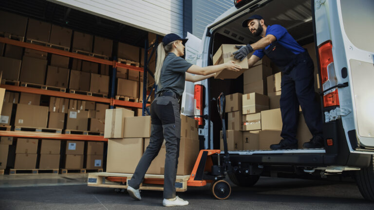 Spouse work permit holders loading boxes in warehouse