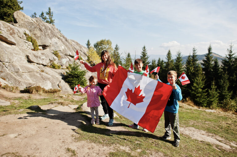 Happy family with Canadian flag