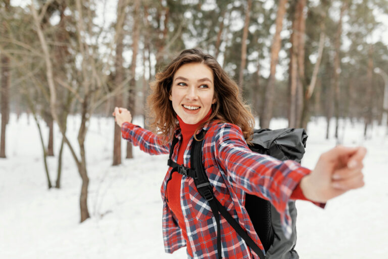 Happy newcomer exploring snowy Canadian forest
