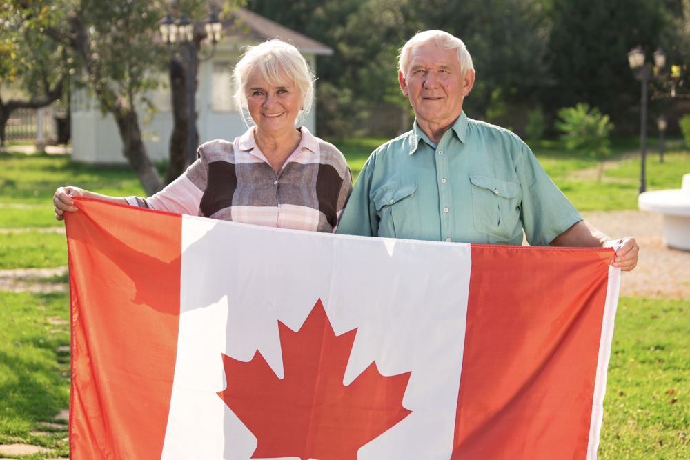Newcomer with Canadian flag in city street