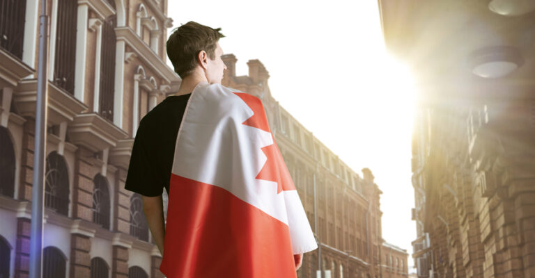 Newcomer with Canadian flag in city street
