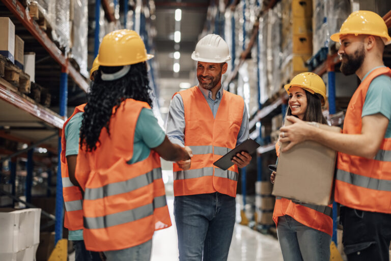 Warehouse workers shaking hands