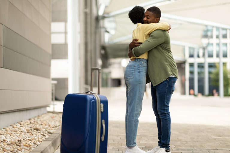 Newcomers embracing at airport Canada