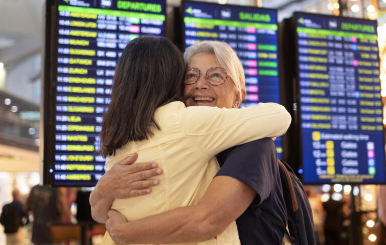 Newcomers embracing at Canadian airport