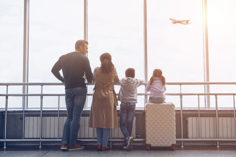 Family watching plane, Canada arrival