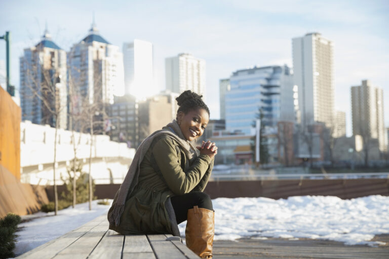 Newcomer sitting in snowy Canadian city.