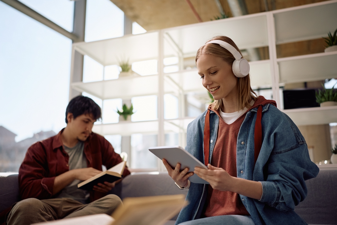 Students collaborating on laptop study.