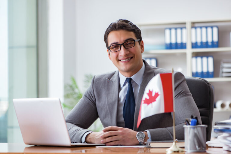 Canadian consultant in office with flag