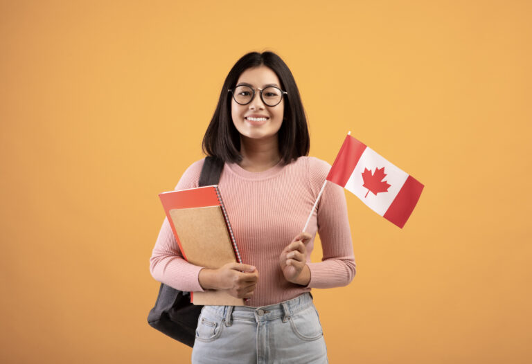 Smiling newcomer with Canadian flag