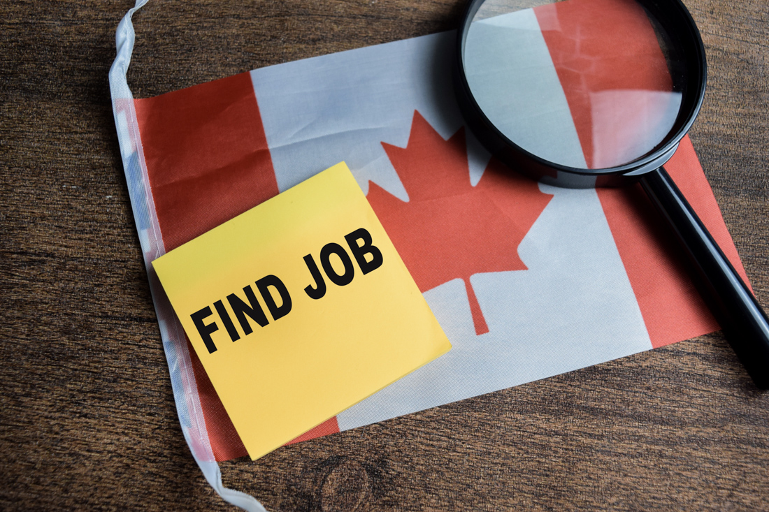 Worker holding Canadian flag proudly