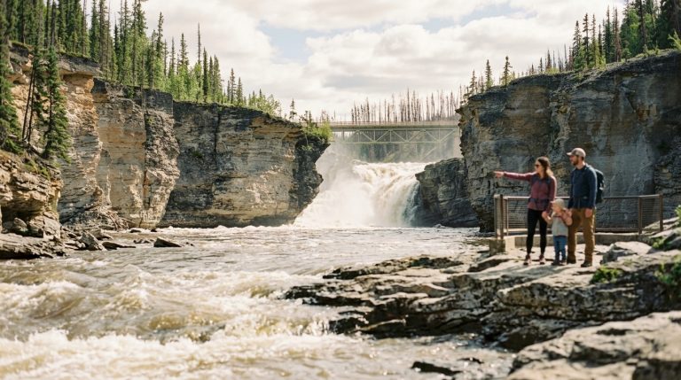 Family stands at a canyon lookout near a Northwest Territories waterfall during latest PNP immigration news
