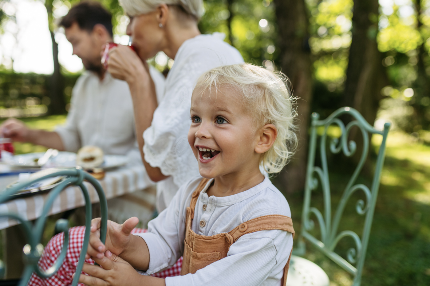 Happy child at family picnic, spouse sponsorship Canada