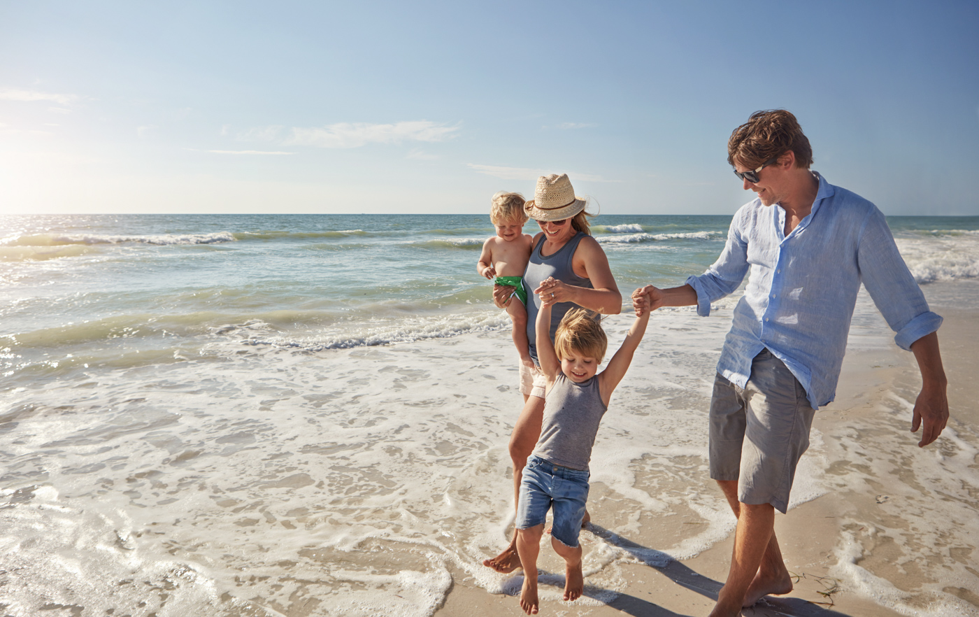 Family walking on beach, spousal sponsorship